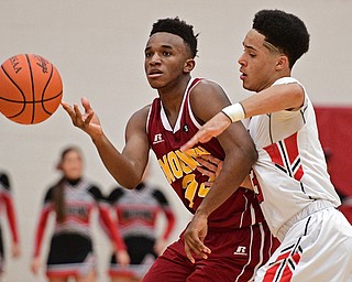 GIRARD, OHIO - DECEMBER 16, 2016: Sonny Rodriguez #23 of Mooney passes the ball while being pressured by Anthony Backus #3 of Girard during the second half of their game Friday night at Girard High School. DAVID DERMER | THE VINDICATOR