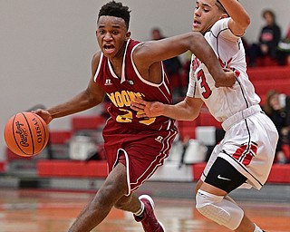 GIRARD, OHIO - DECEMBER 16, 2016: Sonny Rodriguez #23 of Mooney drives on Anthony Backus #3 of Girard during the second half of their game Friday night at Girard High School. DAVID DERMER | THE VINDICATOR