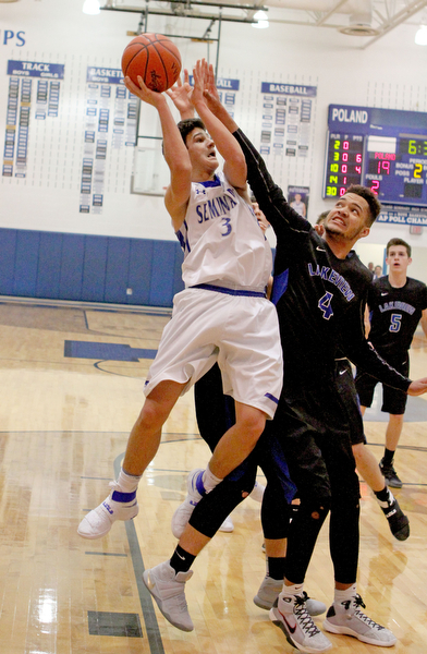 Poland's Braeden O'Shaugnessy (3) goes up for a shot while defended by Lakeview's Jatise Garrison Jr. (4) during the first half of Frifday nights matchup at Poland Seminary High School.  Dustin Livesay  |  The Vindicator  12/16/16  Poland.