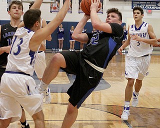 Lakeview's Drew Munno (22) falls back as he takes a shot while being defended by Poland's Brandon Barringer (13) during the second half of Friday nights matchup at Poland Seminary High School.  Dustin Livesay  |  The Vindicator  12/16/16  Poland.