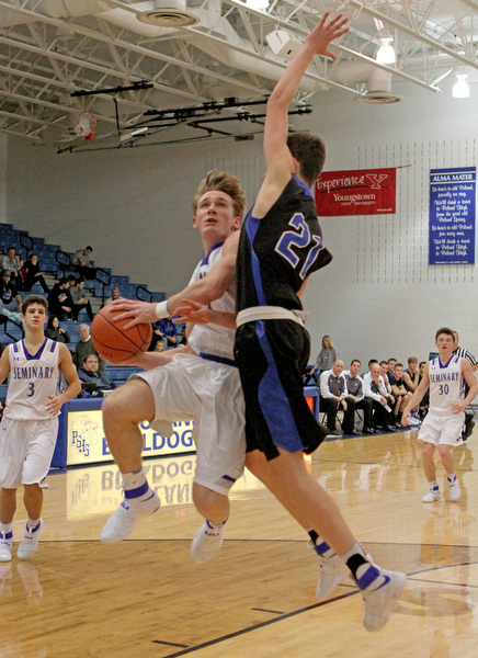 Poland's Konnor Morse (14) goes up for a layup while being defended by Lakeview's Jeffrey Rammick (21) during the second half of Friday nights matchup at Poland Seminary High School.  Dustin Livesay  |  The Vindicator  12/16/16  Poland.