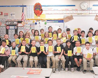 SPECIAL TO THE VINDICATOR
Struthers Rotary continues the Dictionary Project by donating dictionaries to third grade students in Lowellville Elementary. It has donated dictionaries to students in Campbell, Lowellville, Struthers and St. Nicholas schools since 2003 to help them improve writing, reading and creative thinking abilities. Rotarians Tom Baringer, left, and Darla Donahue, presented dictionaries to the class.