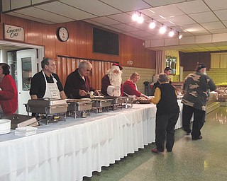 SPECIAL TO THE VINDICATOR
Sts. Peter and Paul Ukrainian Orthodox Church hosted a free community dinner Nov. 29 at The Orthodox Center, 1925 Belle Vista Ave., Youngstown. More than 350 people received dinners from the 25 volunteers, who also prepared 150 lunch bags for children to take to school the next day. The dinner ran out of food. Santa visited with the children.