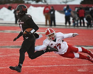 CHENEY, WA - DECEMBER 17: EWU quarterback Gage Gubrud (8) evades the diving tackle attempt of Youngstown State defensive back Billy Nicoe Hurst (17) during the game between the Youngstown State University Penguins and the Eastern Washington University Eagles on December 17, 2016 at Roos Field in Cheney, Washington.  (Photo by Robert Johnson).