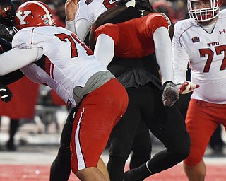 CHENEY, WA - DECEMBER 17: an EWU defenders hoists Youngstown State quarterback Hunter Wells (6) in the air while sacking him during the game between the Youngstown State University Penguins and the Eastern Washington University Eagles on December 17, 2016 at Roos Field in Cheney, Washington.  (Photo by Robert Johnson).