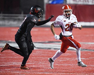 CHENEY, WA - DECEMBER 17: Youngstown State junior running back Jody Webb (20) tries to evade the tackle of EWU sophomore defensive back Mitch Fettig (13) during the game between the Youngstown State University Penguins and the Eastern Washington University Eagles on December 17, 2016 at Roos Field in Cheney, Washington.  (Photo by Robert Johnson).