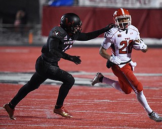 CHENEY, WA - DECEMBER 17: Youngstown State running back Jody Webb (20) tries to get away from EWU defensive back Mitch Fettig (13) during the game between the Youngstown State University Penguins and the Eastern Washington University Eagles on December 17, 2016 at Roos Field in Cheney, Washington.  (Photo by Robert Johnson).