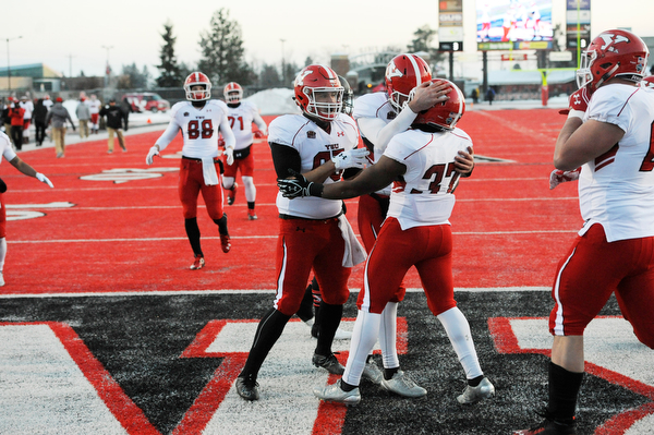 CHENEY, WA - DECEMBER 17: Youngstown State sophomore tailback Kevin McCaster is congratulated after scoring during the game between the Youngstown State University Penguins and the Eastern Washington University Eagles on December 17, 2016 at Roos Field in Cheney, Washington.  (Photo by Robert Johnson).