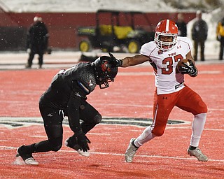 CHENEY, WA - DECEMBER 17: Youngstown State freshman running back Tevin McCaster (37) stiff-arms EWU senior linebacker Miquiyah Zamora (4) during the game between the Youngstown State University Penguins and the Eastern Washington University Eagles on December 17, 2016 at Roos Field in Cheney, Washington.  (Photo by Robert Johnson).
