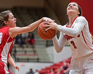 YOUNGSTOWN, OHIO - DECEMBER 17, 2016: Alison Smolinski #2 of YSU goes to the basket while Caroline Shelquist #13 of Cornell hits the ball preventing a shot during the first half of their game Saturday afternoon at the Beeghly Center. Cornell won 80-75. DAVID DERMER | THE VINDICATOR