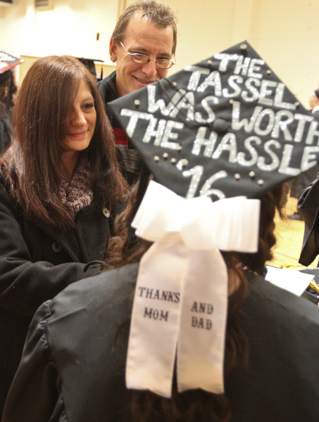 William D. Lewis The Vindicator YSU Criminal Justice grad Monica Woolensack of Springfield has a message on her cap for her parents Christine and Dave Woolensack also of Springfield during the Dec 18, 2016 commencement ceremony at YSU.