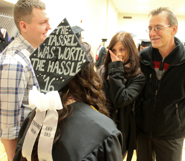 William D. Lewis The Vindicator YSU Criminal Justice grad Monica Woolensack of Springfield has a message on her cap for her parents Christine and Dave Woolensack also of Springfield during the Dec 18, 2016 commencement ceremony at YSU. At left is her boyfriend Austin Bartley.