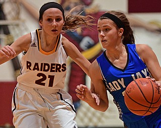CANFIELD, OHIO - DECEMBER 19, 2016: Michaelina Terranova #22 of Jackson Milton drives on Sam Patrone #21 of South Range during the first half of their game Monday night at South Range High School. DAVID DERMER | THE VINDICATOR