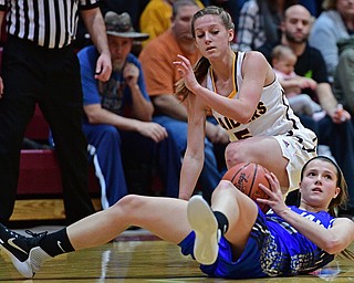 CANFIELD, OHIO - DECEMBER 19, 2016: Michaelina Terranova #22 of Jackson Milton looks to pass the ball to a teammate after securing the loose ball away from Felecia Gatea #5 of South Range during the first half of their game Monday night at South Range High School. DAVID DERMER | THE VINDICATOR