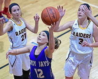 CANFIELD, OHIO - DECEMBER 19, 2016: Kaitlyn Totani #12 of Jackson Milton goes tot he basket after beating Kate Yeagley #3 and Sam Patrone #21 of South Range during the first half of their game Monday night at South Range High School. DAVID DERMER | THE VINDICATOR