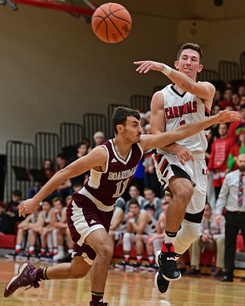 CANFIELD, OHIO - DECEMBER 20, 2016: Jake Cummings #1 of Canfield passes the ball while being pressured by Austin Barone #11 of Boardman during the first half of their game Tuesday night at Canfield High School. DAVID DERMER | THE VINDICATOR