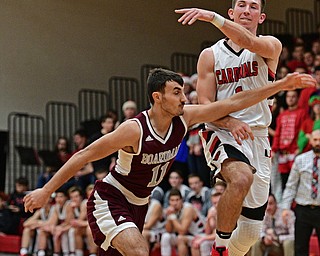 CANFIELD, OHIO - DECEMBER 20, 2016: Jake Cummings #1 of Canfield passes the ball while being pressured by Austin Barone #11 of Boardman during the first half of their game Tuesday night at Canfield High School. DAVID DERMER | THE VINDICATOR