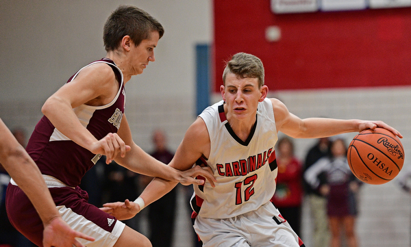 CANFIELD, OHIO - DECEMBER 20, 2016: Ethan Kalina #12 of Canfield drives on Sebastian Heinonen #21 of Boardman during the second half of their game Tuesday night at Canfield High School. DAVID DERMER | THE VINDICATOR
