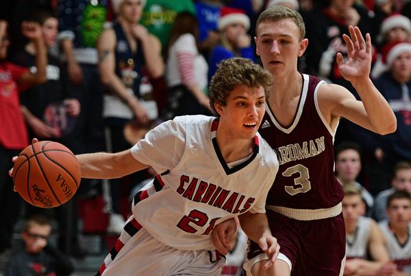 CANFIELD, OHIO - DECEMBER 20, 2016: Zach Tinkey #21 of Canfield drives on Holden Lipke #3 of Boardman during the second half of their game Tuesday night at Canfield High School. DAVID DERMER | THE VINDICATOR