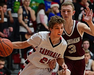 CANFIELD, OHIO - DECEMBER 20, 2016: Zach Tinkey #21 of Canfield drives on Holden Lipke #3 of Boardman during the second half of their game Tuesday night at Canfield High School. DAVID DERMER | THE VINDICATOR