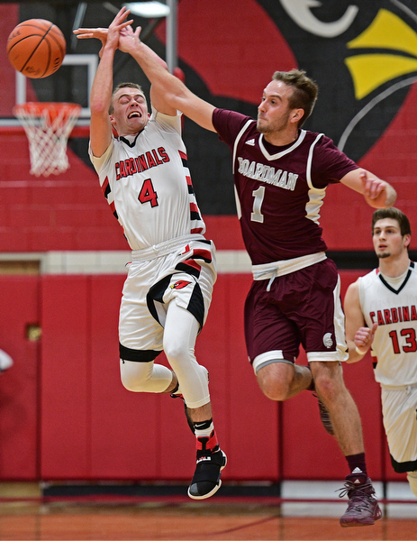CANFIELD, OHIO - DECEMBER 20, 2016: Brandon McFall #4 of Canfield has the ball knocked out of his control by John Ryan as the two fly through the air during the second half of their game Tuesday night at Canfield High School. DAVID DERMER | THE VINDICATOR