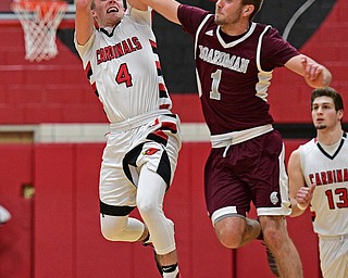 CANFIELD, OHIO - DECEMBER 20, 2016: Brandon McFall #4 of Canfield has the ball knocked out of his control by John Ryan as the two fly through the air during the second half of their game Tuesday night at Canfield High School. DAVID DERMER | THE VINDICATOR