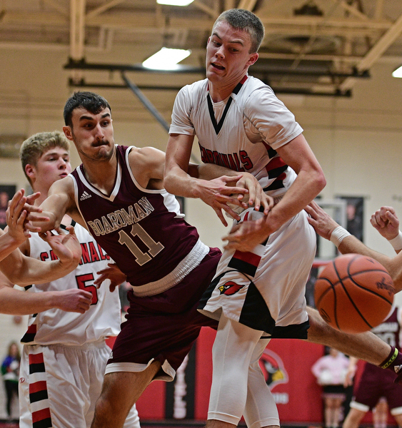 CANFIELD, OHIO - DECEMBER 20, 2016: Brandon McFall #4 of Canfield has the rebound knocked out of his control by Austin Barone #11 of Boardman under the basket during the second half of their game Tuesday night at Canfield High School. DAVID DERMER | THE VINDICATOR