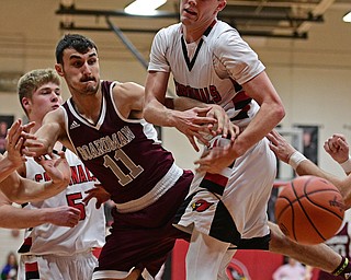 CANFIELD, OHIO - DECEMBER 20, 2016: Brandon McFall #4 of Canfield has the rebound knocked out of his control by Austin Barone #11 of Boardman under the basket during the second half of their game Tuesday night at Canfield High School. DAVID DERMER | THE VINDICATOR