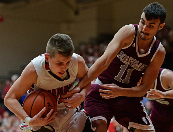 CANFIELD, OHIO - DECEMBER 20, 2016: Ethan Kalina #12 of Canfield secures the rebound away from Austin Barone #11 of Boardman during the second half of their game Tuesday night at Canfield High School. DAVID DERMER | THE VINDICATOR