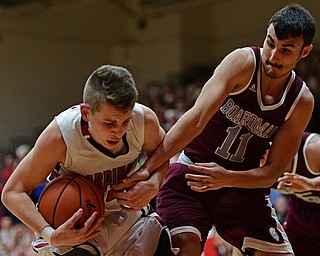 CANFIELD, OHIO - DECEMBER 20, 2016: Ethan Kalina #12 of Canfield secures the rebound away from Austin Barone #11 of Boardman during the second half of their game Tuesday night at Canfield High School. DAVID DERMER | THE VINDICATOR