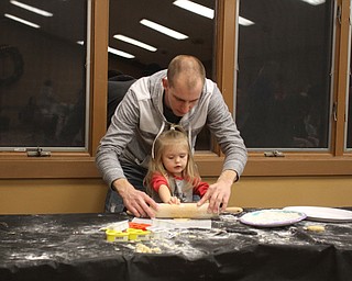 Kent McMurray helps his daughter Alyse Paige(2.5) while making Cookies for Santa at Boardman Park's Lariccia Community Center in Boardman Park's Lariccia Community Center on Wednesday, Dec. 21, 2016...(Nikos Frazier | The Vindicator)..
