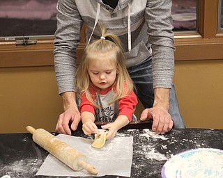 Kent McMurray helps his daughter Alyse Paige(2.5) while making Cookies for Santa at Boardman Park's Lariccia Community Center in Boardman Park's Lariccia Community Center on Wednesday, Dec. 21, 2016...(Nikos Frazier | The Vindicator)..