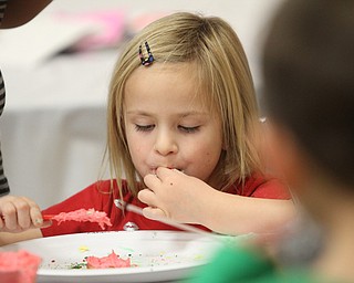 Addison Malysa(5) of Boardman samples some icing while making Cookies for Santa at Boardman Park's Lariccia Community Center in Boardman Park's Lariccia Community Center on Wednesday, Dec. 21, 2016...(Nikos Frazier | The Vindicator)..