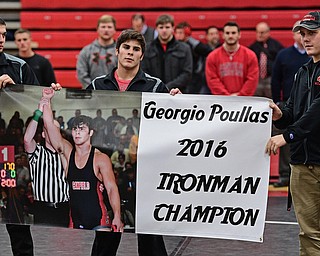 CANFIELD, OHIO - DECEMBER 21, 2016: Canfield wrestler Georgio Poullas of Canfield is presented with a banner celebrating his Ironman wrestling tournament championship, Wednesday evening at Canfield High School. DAVID DERMER | THE VINDICATOR