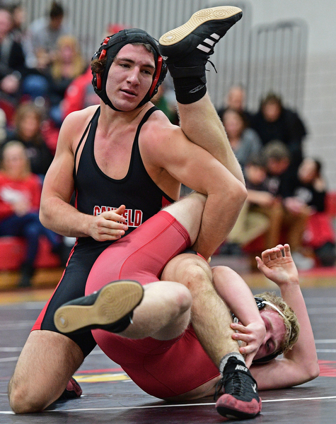 CANFIELD, OHIO - DECEMBER 21, 2016: Dominic Cooper of Canfield controls the body of Daniel Wirth of Beaver Local during their 182lb bout Wednesday night at Canfield High School. DAVID DERMER | THE VINDICATOR