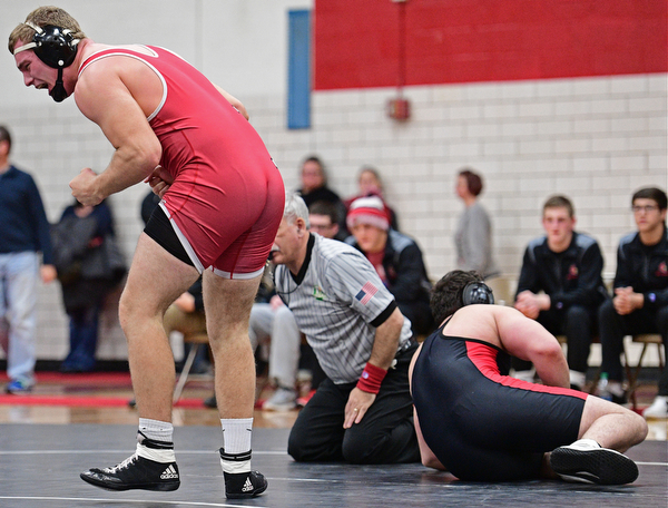 CANFIELD, OHIO - DECEMBER 21, 2016: Garrett Givens of Beaver Local celebrates after pinning Hunter Mersing of Canfield after their 220lb bout Wednesday night at Canfield High School. DAVID DERMER | THE VINDICATOR