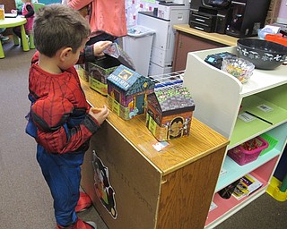 Neighbors | Alexis Bartolomucci.One of the students at Hitchcock Woods Learning Center put his hand in boxes to feel what different Halloween items felt like on Oct. 27 during the Fall Harvest Party.