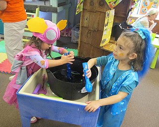 Neighbors | Alexis Bartolomucci.Two of the girls at Hitchcock Woods Learning Center stirred the witches brew in their costumes during the Harvest Fall Party on Oct. 27.