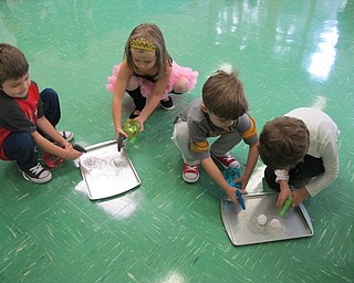 Neighbors | Alexis Bartolomucci.Students in Samantha Cox and Joy Bucci's classes sprayed baking soda clumps with vinegar until the clumps dissolved and the students got a surprise.