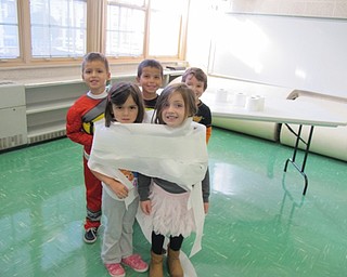 Neighbors | Alexis Bartolomucci.Students wrapped each other up in toilet paper like mummies during Halloween science activities at North Preschool on Oct. 31.
