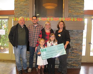 Neighbors | Alexis Bartolomucci.Janette Neal gave Hannah Tringhese and her family a check for the proceeds raised at the spaghetti dinner on Oct. 22. Pictured are, from left, (back) Larry Pennington, Tom Tringhese, Sarah Tringhese and Janette Neal; (front) Abby Tringhese and Hannah Tringhese.