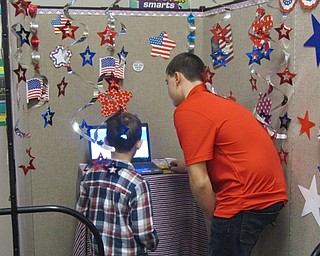 Neighbors | Submitted.Michael Pelini assists Landon Gallagher with his electronic vote.