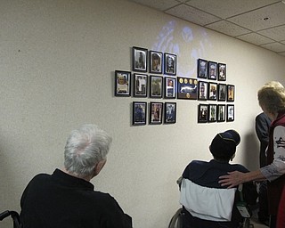 Neighbors | Alexis Bartolomucci.Navy veterans, Charles (Ben) Hostetter and Paul Salata, looked at their pictures on the Wall of Valor at Beeghly Oaks on Nov. 22.