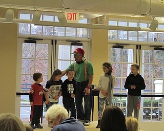 Neighbors | Alexis Bartolomucci.Children were called up to the stage to help Don Monopoli perform holiday songs during the Poland library's Children's Holiday Journey program on Nov. 26.