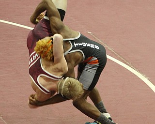 Geshauun Matlock(black) throws Cade Pollak(red) to the mat in the Boardman High School Gymnasium on Thursday, Dec. 22, 2016...(Nikos Frazier | The Vindicator)..