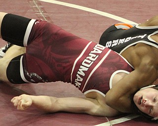 Geshauun Matlock(black) locks Cade Pollak(red)in a headlock in the Boardman High School Gymnasium on Thursday, Dec. 22, 2016...(Nikos Frazier | The Vindicator)..