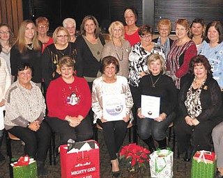 SPECIAL TO THE VINDICATOR
GFWC Ohio Austintown Junior Women’s League met for its annual Christmas dinner and meeting recently at Rachel’s Restaurant. Members and guests celebrated the holiday with dinner while making plans for an upcoming fundraiser, “The Taste of Austintown.” Members donated unwrapped gifts for Beatitude House and AJWL also contributed two $100 gift cards for needy families in Austintown. If interested in becoming a member, visit Facebook.com/AJWL2014. Those attending the event, in front from left, are Joann Sulenski; Eileen Frost, secretary; Kathy Rusback, president; Linda Jones, first vice president; and MaryeKay Erickson, treasurer. In row two are Jan Zoccali, Sandy Gaskill, Ellen Kosa, Stephanie Oyster, Colleen Miller, Janette Neal, Mary Toporcer, Judy Rodkey, Janice Simmerman, Peggy Bennett, Paulette Dockry, Sue Hovanec and Marie Dockry. In back are Ruty Rodriguez-Patterson, Jennifer Lambert, Ryanne Lambert, Jessica Munger, Janie Surman, Donna Wear, Genevieve Bodnar, Nancy Jones, Chrissy Bloom, Eileen Lozier and Maribeth McGlynn.
