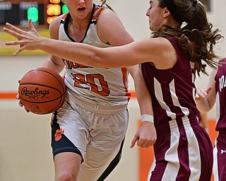 HOWLAND, OHIO - DECEMBER 23, 2016: Sara Price #20 of Howland drives on Jenna Vivo #5 of Boardman during the second half of their game Friday night at Howland High School. DAVID DERMER | THE VINDICATOR