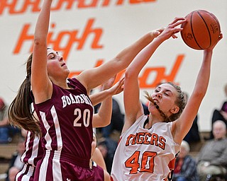 HOWLAND, OHIO - DECEMBER 23, 2016: Kayla Clark #40 of Howland grabs a rebound away from Lauren Gabriele #20 of Boardman during the second half of their game Friday night at Howland High School. DAVID DERMER | THE VINDICATOR