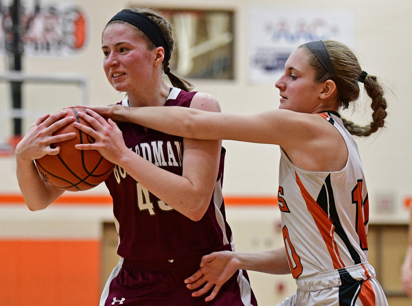 HOWLAND, OHIO - DECEMBER 23, 2016: Annalisa Cordova #43 of Boardman attempts to rip the ball away from Gabby Hartzell #10 of Howland during the second half of their game Friday night at Howland High School. DAVID DERMER | THE VINDICATOR